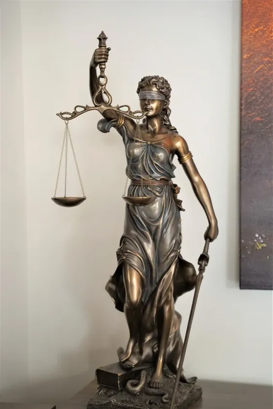 A statue of Lady Justice holding the Scales of Justice, symbolising the Director PPS Number Requirement.