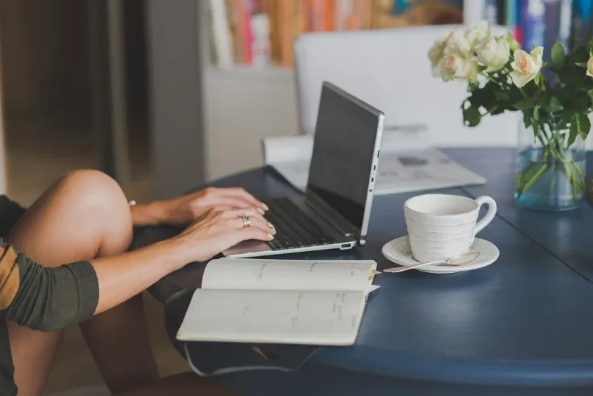 Man having a business call at his desk with a laptop, illustrating Work From Home Allowance scheme in Ireland.
